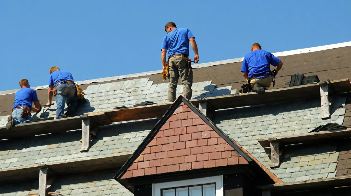 Roof replacement in progress with a team of professional contractors installing new shingles on a residential home in Santa Ana, CA